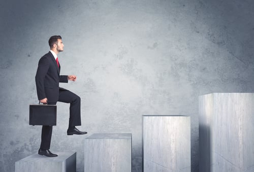 Man in business suit climbing steps